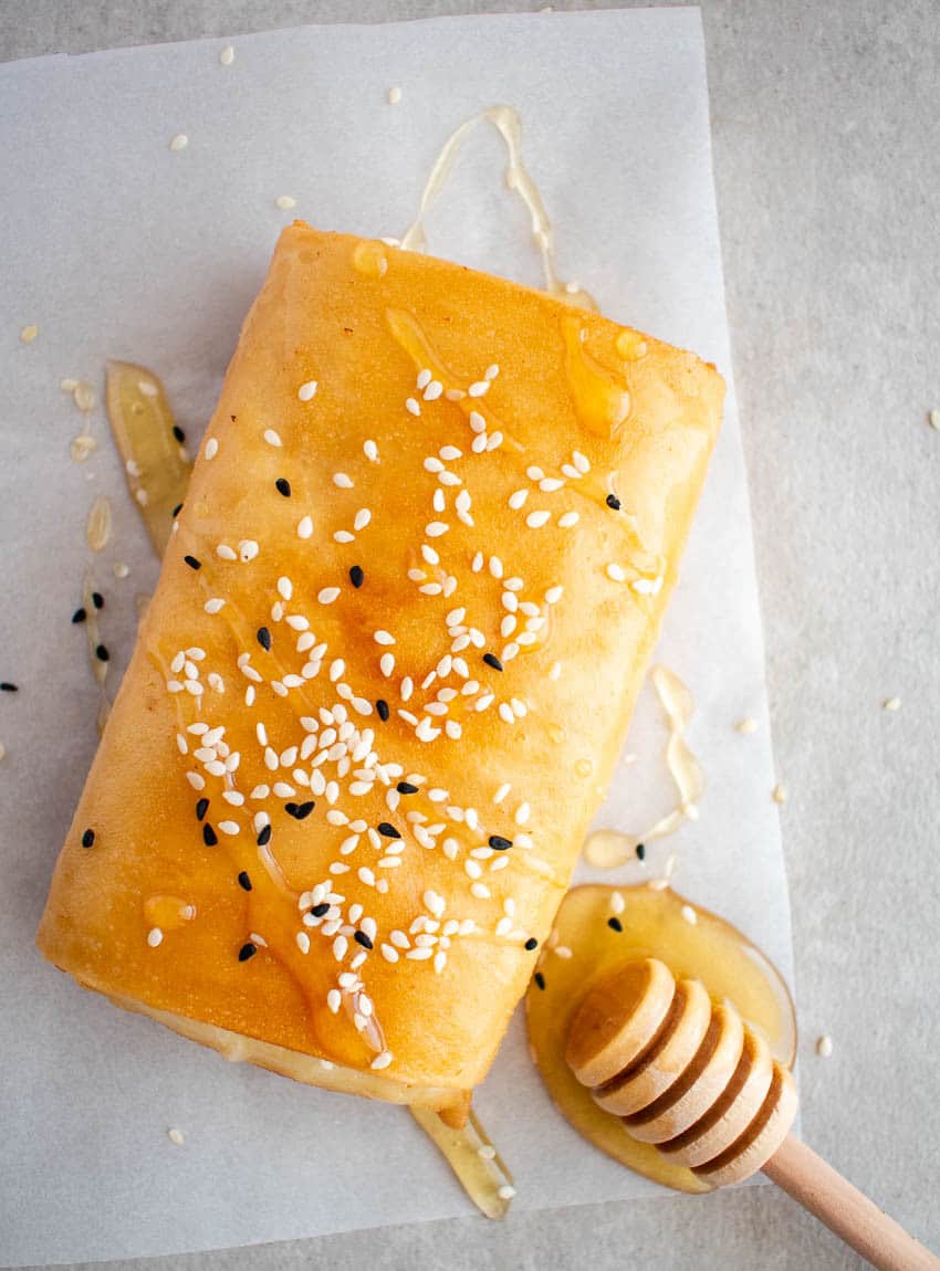 Fried feta cheese wrapped in filo pastry, with honey and sesame